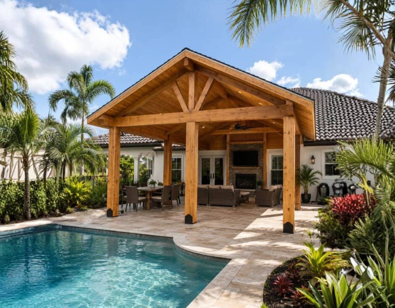 Gable pavilion with fireplace beside pool